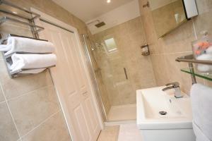 y baño con ducha y lavamanos. en Apple Tree Place B&B en Tadley