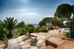 a patio with a table and chairs and a pool at Casa de l’Albada in Roses
