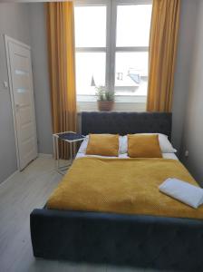 1 cama en un dormitorio con ventana grande en MALTINA, en Malbork
