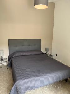 מיטה או מיטות בחדר ב-Les Jardins De Santa Giulia - Charmante chambre d'hôte 1
