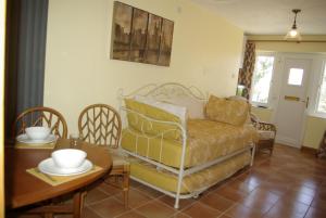 a living room with a couch and a table at Rural retreat, central location, close to beaches in Camborne