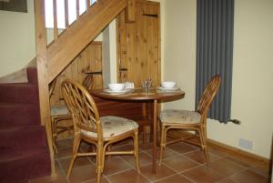 a dining room with a table and two chairs at Rural retreat, central location, close to beaches in Camborne