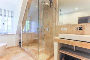 a bathroom with a shower and a sink at Sommerhaus in Keitum +48 photos