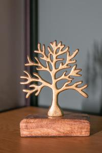 a small bronze tree ornament on a wooden table at Santa Marina in Ioannina
