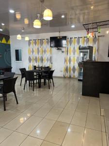 a dining room with tables and chairs in a restaurant at Sky Inn Hotel in Freetown
