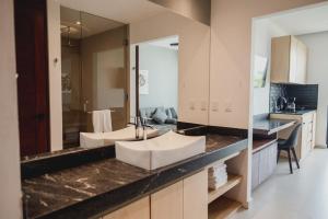 a bathroom with two sinks and a large mirror at Phantom Suites in Playa del Carmen +29 photos