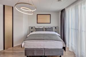 Postel nebo postele na pokoji v ubytování MOOI Apartments Schlieren