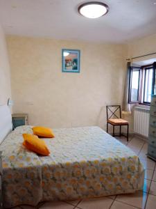 a bedroom with a bed with two pillows on it at Casa girasole in Isola del Giglio