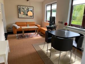 a living room with a couch and a table at Forellenhof in Nordhastedt