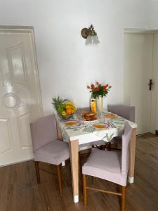 a table with a plate of food and flowers on it at Lora in Skradin