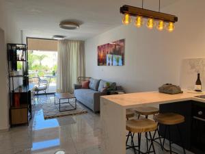 a kitchen and living room with a couch and a table at lasuita-exclusive suites ceserea-luxury suite in Caesarea