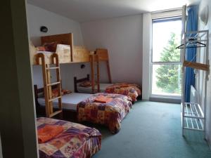 a room with three bunk beds and a window at MONTLO RELAIS DES CERFS in Mas-dʼOrcières