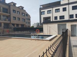 a swimming pool in the middle of a building at Apartamento Sofía in Llanes