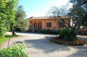 dom z drzewem i kwiatami przed nim w obiekcie Casa Grion w mieście Corchiano