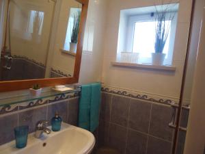 a bathroom with a sink and a mirror at Casa da Pedralva in Nazaré +46 photos