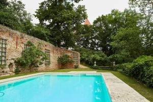 uma piscina em frente a uma parede de tijolos em Exklusiver, privater Schlosstrakt im Schloss Horn em Horn