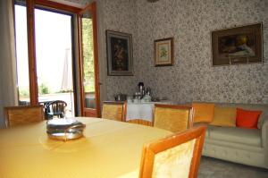 a living room with a table and a couch at Casa Grion in Corchiano