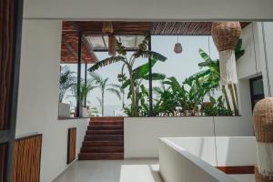 a house with a large window with plants at Phantom Suites in Playa del Carmen