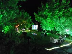 a group of chairs and a screen in a park at night at Bahçeli Konak in Eceabat