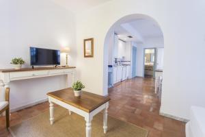 - un salon avec une table et une cheminée dans l'établissement Apartamentos Suites Santa Cruz, à Séville