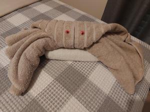a stuffed elephant is laying on a bed at Luxury Home in Spáta
