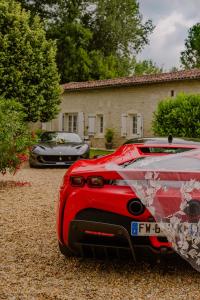 deux voitures garées devant une maison dans l'établissement Le Logis de la Soloire, à Nercillac