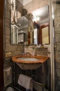 a bathroom with a sink and a mirror at Ai Due Fanali in Venice