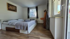 a bedroom with a bed with blue pillows on it at Apartma Julija in Luče