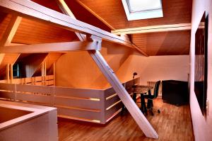 a attic room with a wooden staircase and a table at Prophetengut - die Perle im Jurapark in Habsburg