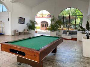 a pool table in the middle of a room at Flat Aquamare Monte Vista in Sosúa