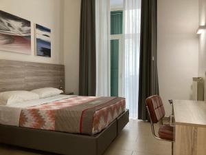 a hotel room with a bed and a window at 4STANZE in Naples