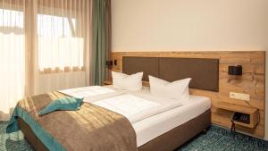 Voodi või voodid majutusasutuse Das Wiesgauer - Alpenhotel Inzell toas