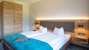 Voodi või voodid majutusasutuse Das Wiesgauer - Alpenhotel Inzell toas