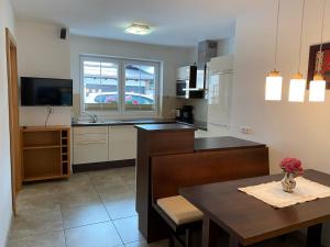 a kitchen with a table and a dining room at Appartement Maria in Westendorf