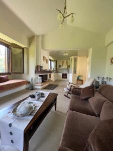 a living room with a couch and a table at Casa verde ver in Makrirrákhi +21 photos