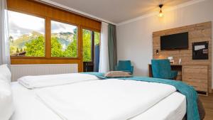 Voodi või voodid majutusasutuse Das Wiesgauer - Alpenhotel Inzell toas