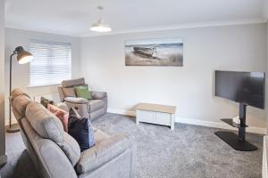 a living room with a couch and a flat screen tv at Host & Stay - Aynsley Mews in Consett