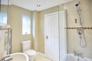 a bathroom with a toilet and a shower and a sink at Host & Stay - Aynsley Mews in Consett