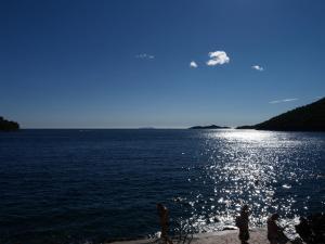 people standing on the shore of a large body of water at Brna Three-room apartment near the beach-Zen in Brna