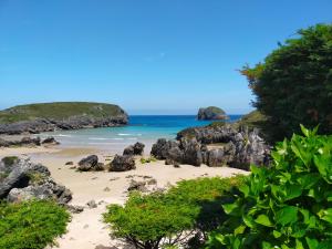 a beach with rocks and the ocean in the background at Apartamento Sofía in Llanes