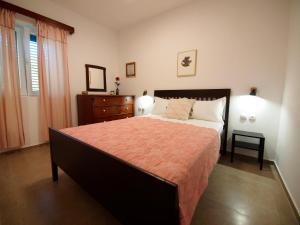 a bedroom with a large bed and a dresser at Brna Three-room apartment near the beach-Zen in Brna