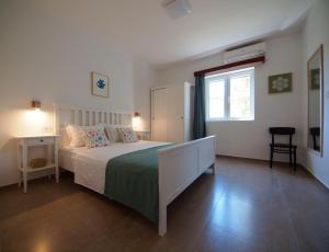 a bedroom with a large bed and a window at Brna Three-room apartment near the beach-Zen in Brna
