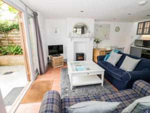 a living room with a couch and a table at Homestead Cottage in Shipston-on-Stour