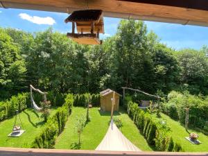 a garden with a hammock and a playground at Ferienwohnung Lisl in Holzkirchen