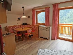 a kitchen and dining room with a table and chairs at Ferienwohnungen Böhm in Sankt Jakob in Defereggen
