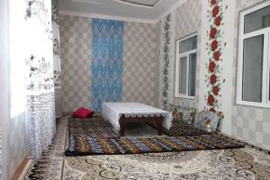 a room with a bench sitting on a rug at FOREST Guest House in Mirzakishlak