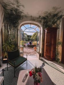 una puerta abierta a una habitación con una silla y una mesa en Villa Biondelli Wine & Suites, en Cazzago San Martino