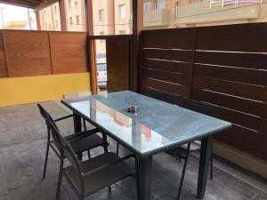 a glass table and chairs in a room at Espacio Room Fuerteventura in Puerto del Rosario