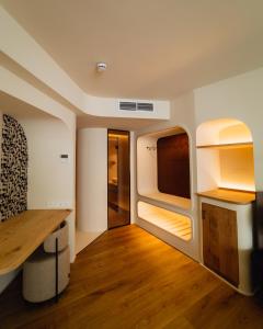 a small room with a desk and a tv at Pacha Hotel in Ibiza Town