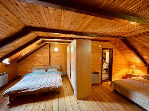 a room with two beds in a wooden house at Sky High Kolasin in Kolašin